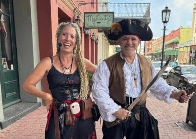Two people dressed as pirates on a historic street in Galveston, Texas.